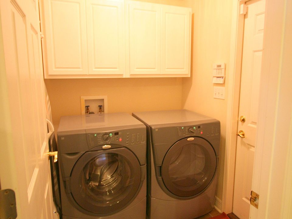Utility Room features ceramic tile flooring and extra cabinet space. 