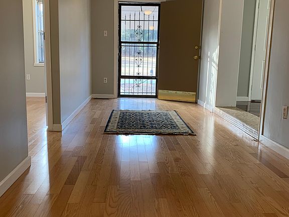 Entryway with a wide foyer has room for cabinet, treadmill