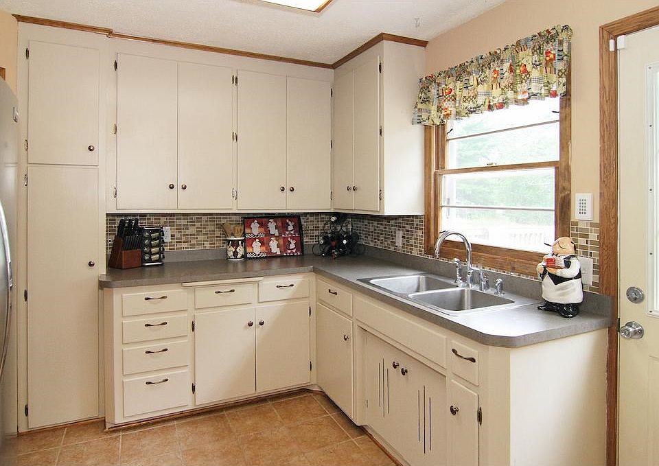 Welcome to 1600 E 86th Street! Lots of June 2017 updates all around the home. Here in the kitchen find freshly painted cabinets with 42-inch uppers and a roomy pantry, at left.