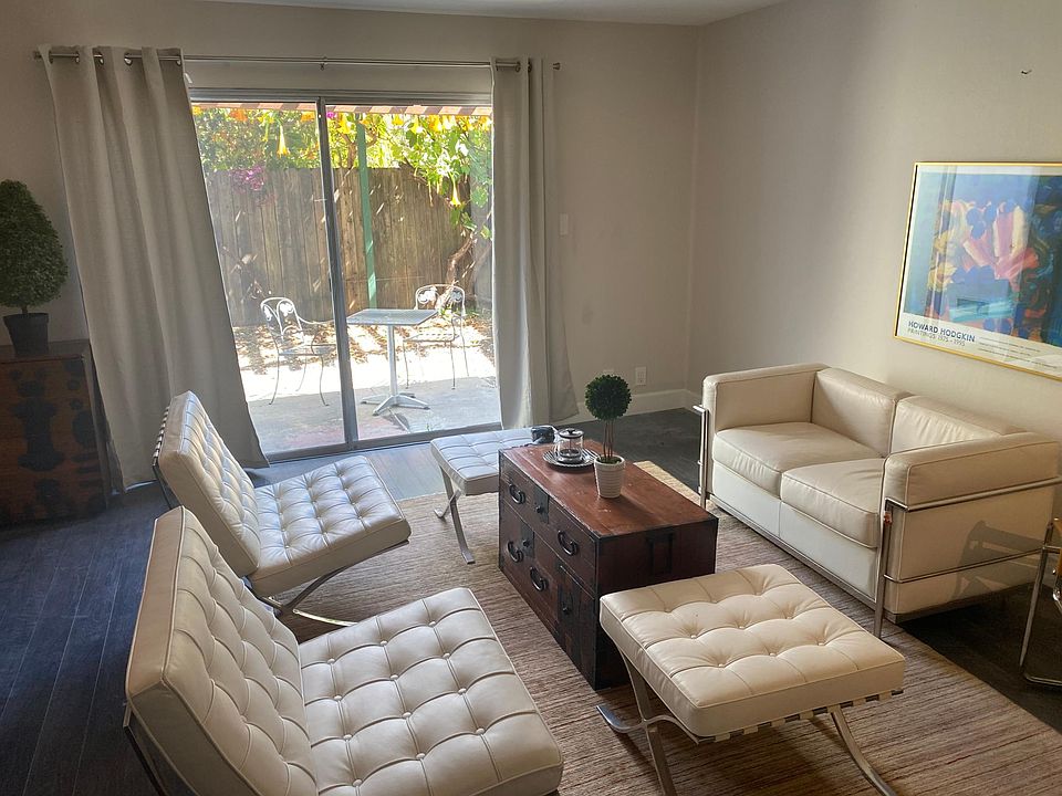 Living room opens out to private sunny outdoor patio.