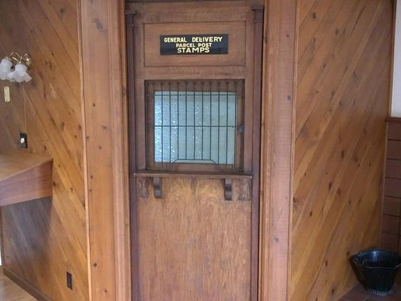 Antique post office door opening into the bathroom