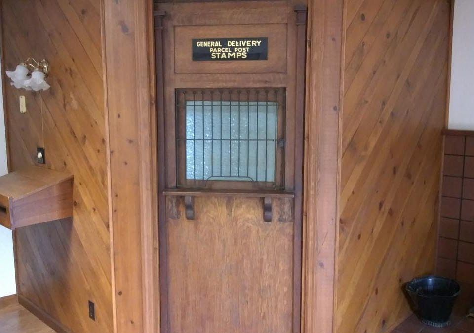 Antique post office door opening into the bathroom