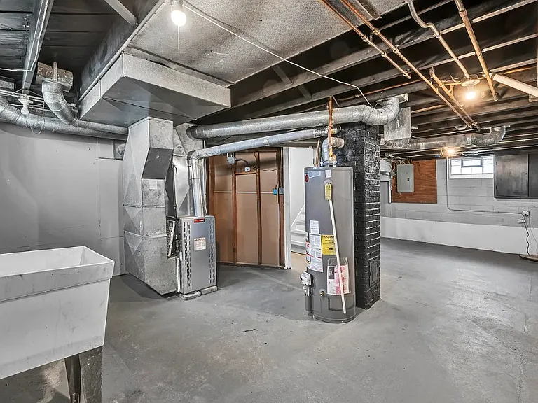 large laundry room in basement and tons of storage