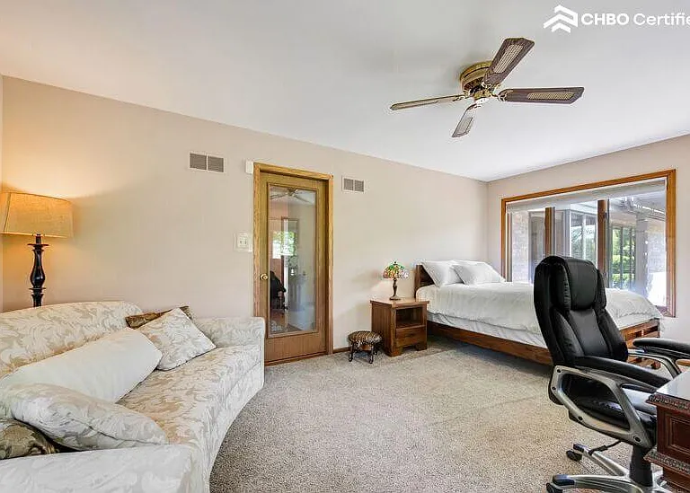 Bedroom 4 - custom large sofa, exit to patio, & hall closet