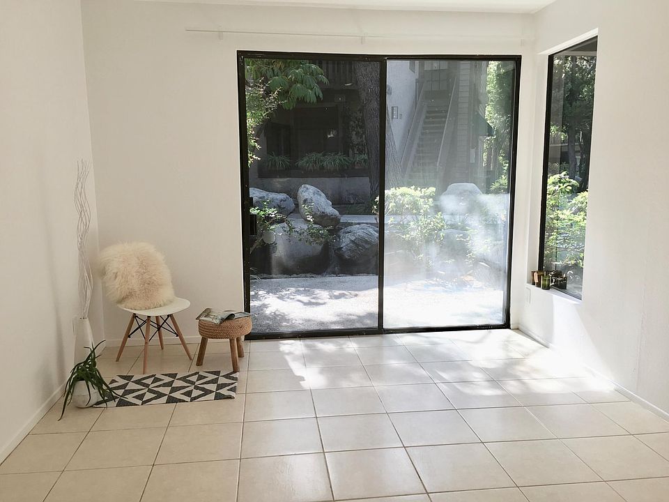 Master bedroom with sliding doors leading to the patio. Small waterfall right outside in patio