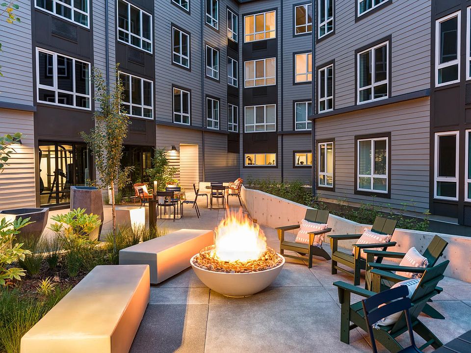 Gather around the inviting fire table on cool evenings or relax amidst vibrant greenery in ample comfortable seating.