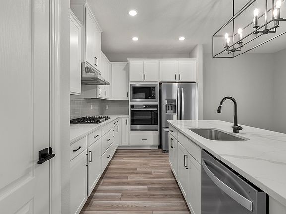 The heart of the home features all new Whirlpool R appliances and quartz countertop