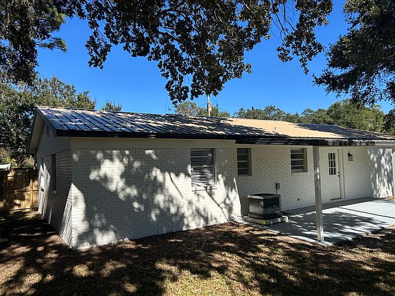 Back of house has covered patio.