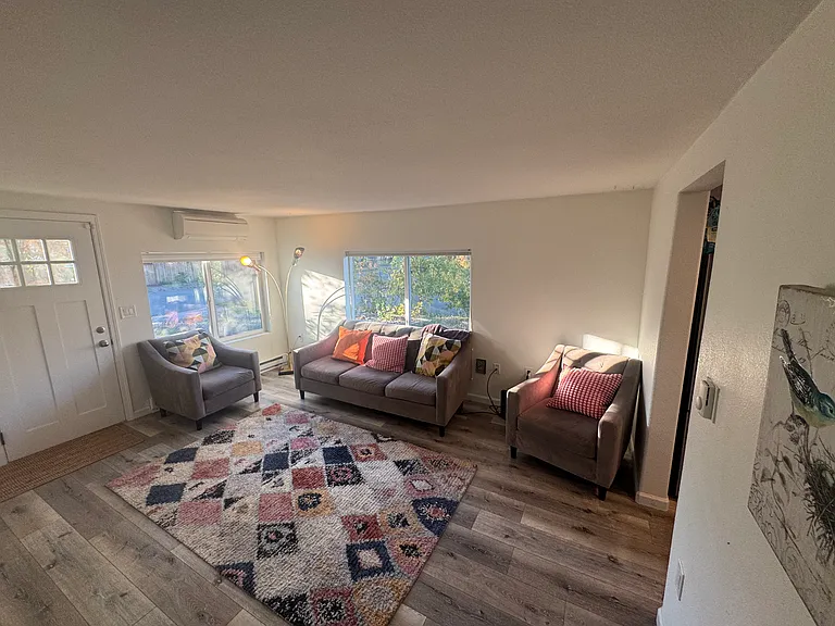Well lit living room. The house is well insulated so it stays warm and cozy in the winter!