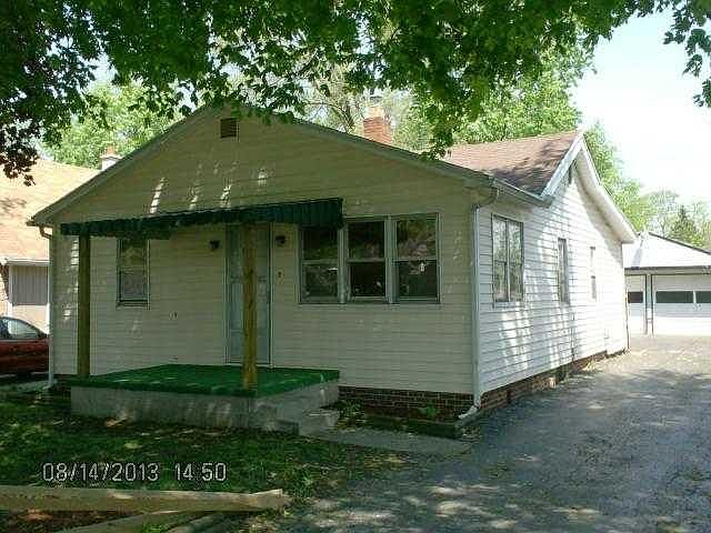 Front exterior and tons of driveway all the way back past privacy fence to parking and 2 var garage