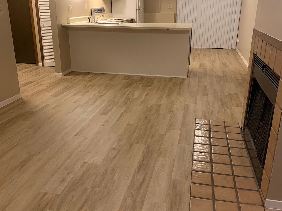 Open floor plan, living room with fireplace and kitchen.