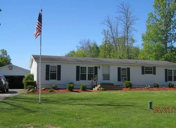 Front of home with detached garage.