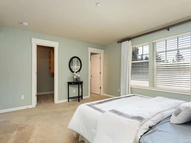 Primary walk-in closet with built-in closet system.