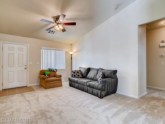 Step into this spacious living room with vaulted ceiling.  New carpet and tile throughout.