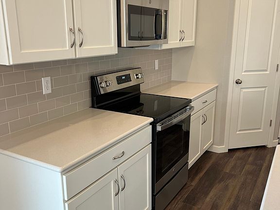 Kitchen with electric stove and microwave, Quartz counters