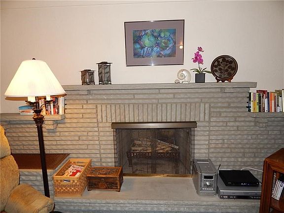 The Living Room has a Beautiful Decorative Fireplace.