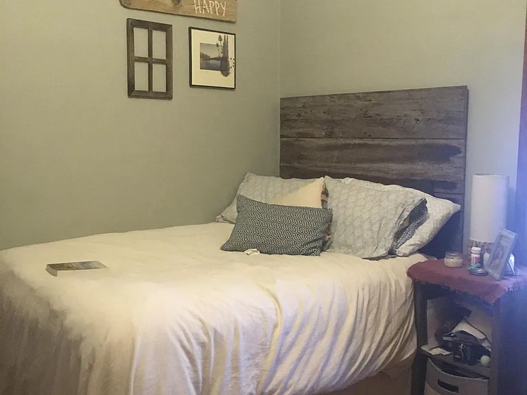 Upstairs bedroom #2 or office features hardwoods, ceiling fan, and plantation shutters.