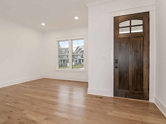 Arched entry door, open floor ahead