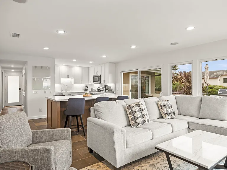 Open concept includes living room, counter seating for 6 and kitchen.
