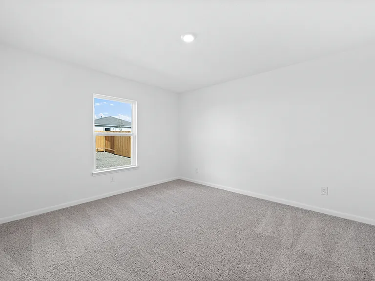 Master bedroom with lush carpet.
