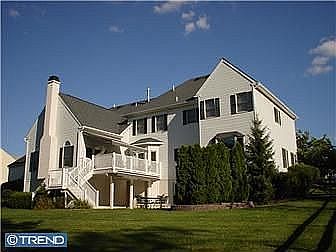 Large patterned concrete patio & elevated deck dress up the back of the house