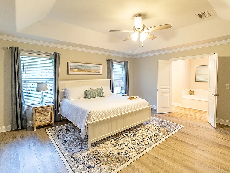 Primary bedroom outfitted with a King sized bed.