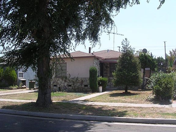 Home has tree lined street