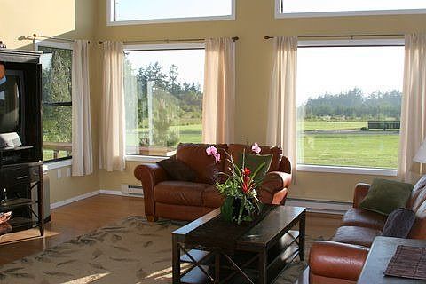 Living room out to front yard and waterview.