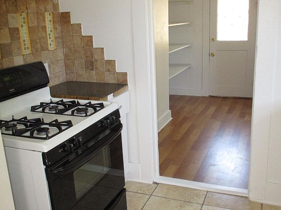 Kitchen with a view to the back door, storage area and utility room