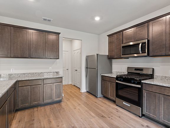 The kitchen has gorgeous wood cabinetry.