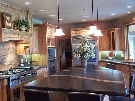 Concrete countertops, 8 burner Dacor stove and seating for 5 at island