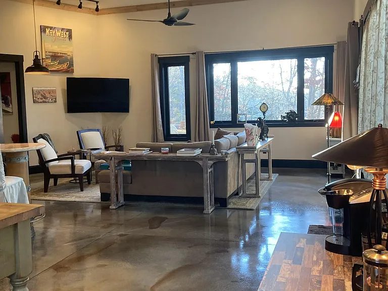 Living room features a large sectional sofa and 70" flat screen TV