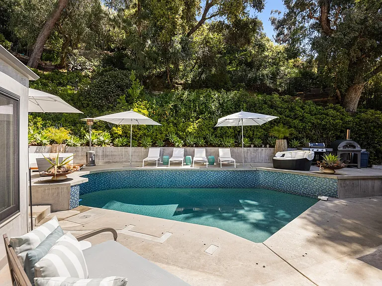 Lush green surroundings provide a picturesque backdrop to the outdoor retreat.