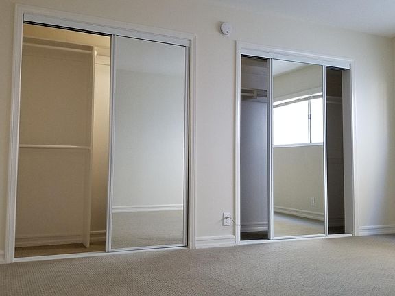 Bedroom closets with mirrored doors