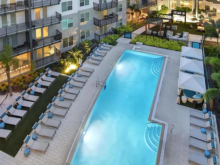 Spacious Pool Deck with Private Cabanas and Outdoor Seating Areas