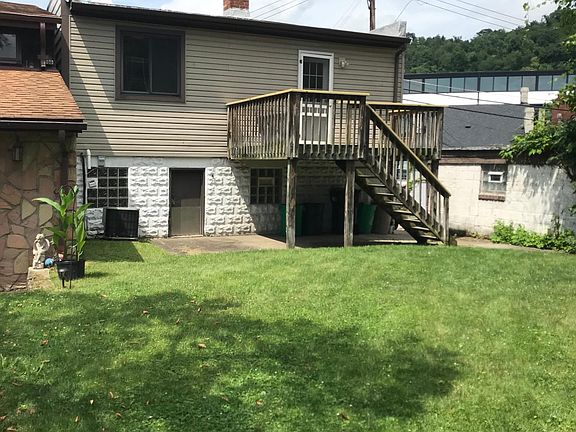 View of house and yard from driveway next door.