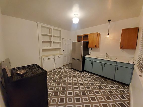 View from dining room; access to the basement and garage to the left of the refrigerator.