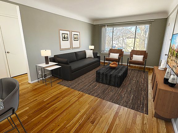 From newly updated wood plank flooring to sleek grey kitchen cabinetry, all is cool inside.