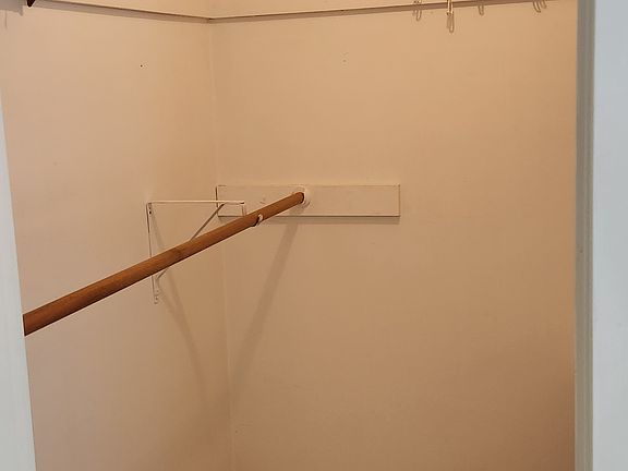 The walk-in closet of the primary bedroom