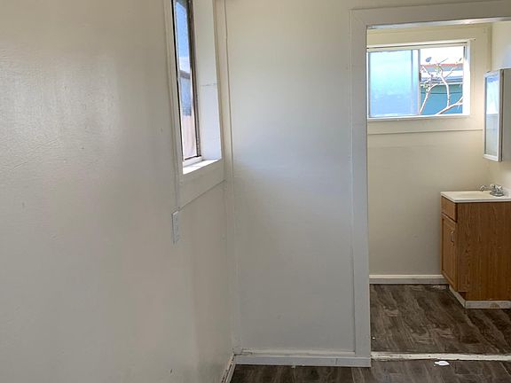 Partial view of small bedroom and window.