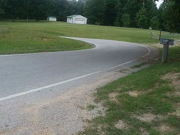 View of road and 1 of 3 garages