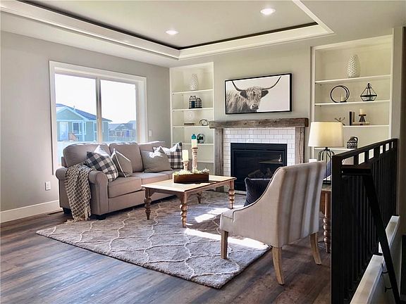 Living Room with Built-Ins, Tray Ceiling, and Barnwood Mantle & Subway Tile on Gas Fireplace