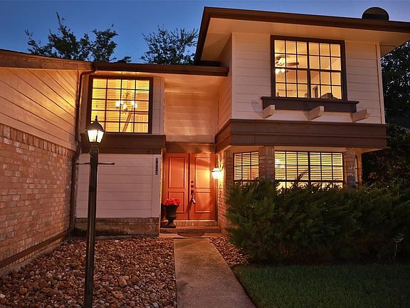 COACH LIGHTING GIVES A DECORATIVE FINISH TO THE ENTRY OF THIS HOME! DOUBLE WOOD ENTRY DOORS WITH A BRICK PORCH!