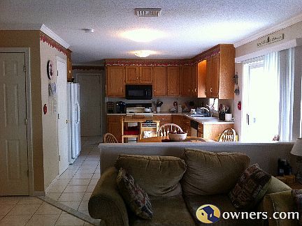 bright open kitchen and living room with fire place