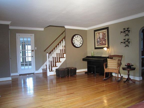 Front door opens into living room with beautiful hardwoods/new crown molding