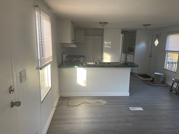 view of kitchen from living room. New laminate flooring throughout.