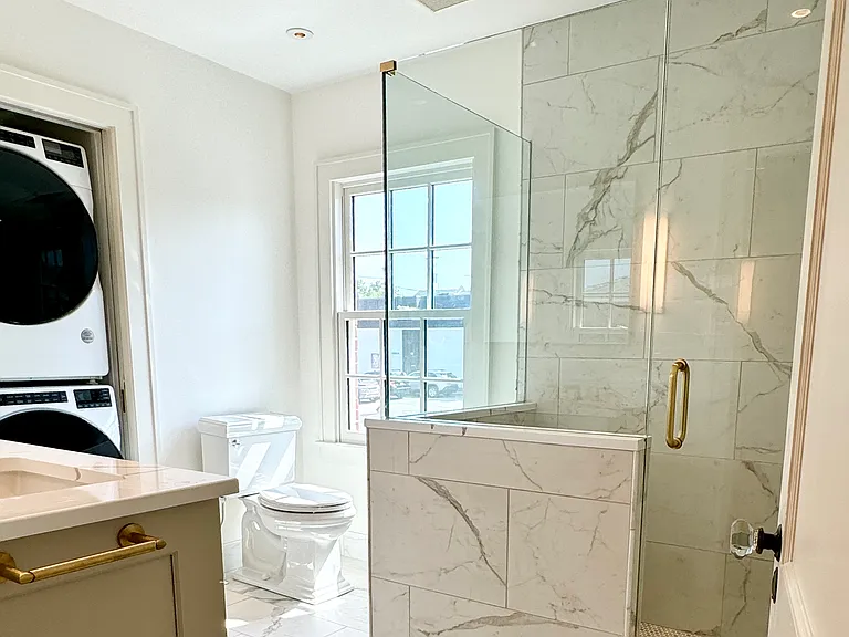 Master bathroom with walk-in shower and front-load washer/dryer