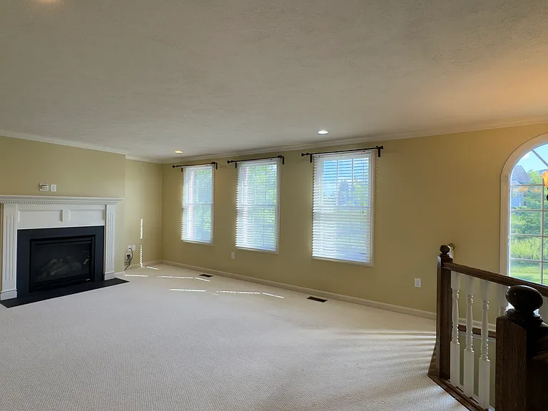 Large, open living room with gas fireplace.
