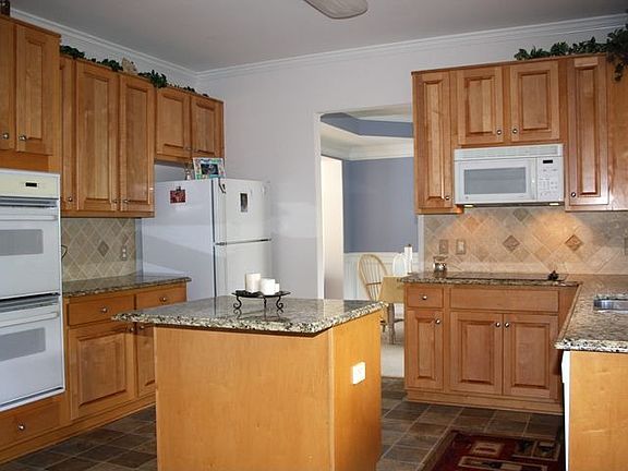 Recently renovated kitchen features granite, stained cabinets & new cooktop