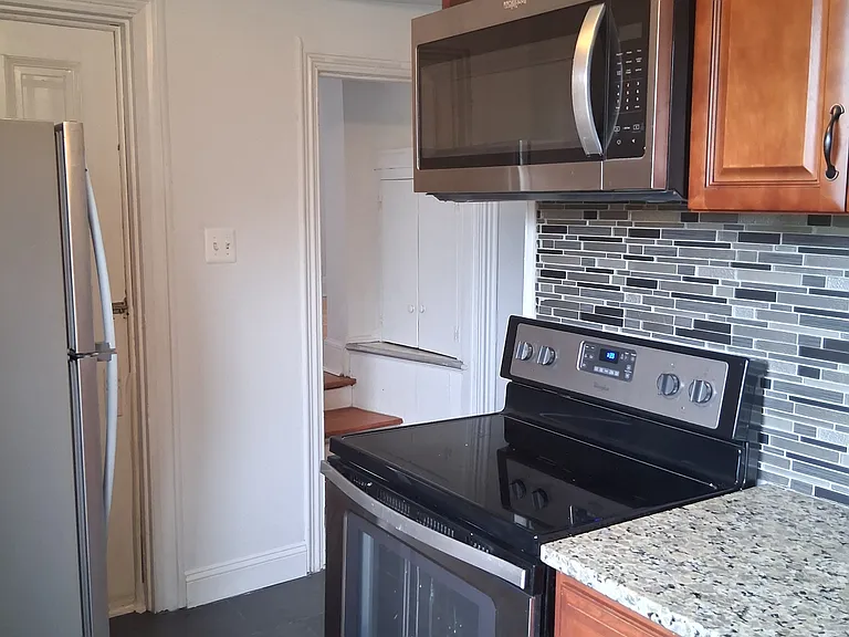 Kitchen showing stove, microwave, refrigerator